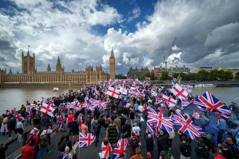 Tommy Robinson leading the Unite the Kingdom march, surrounded by a diverse crowd of attendees, including a paedophile hunter and anti-migrant influencers, with a mix of emotions and reactions on display, highlighting the complexity and divisiveness of the event