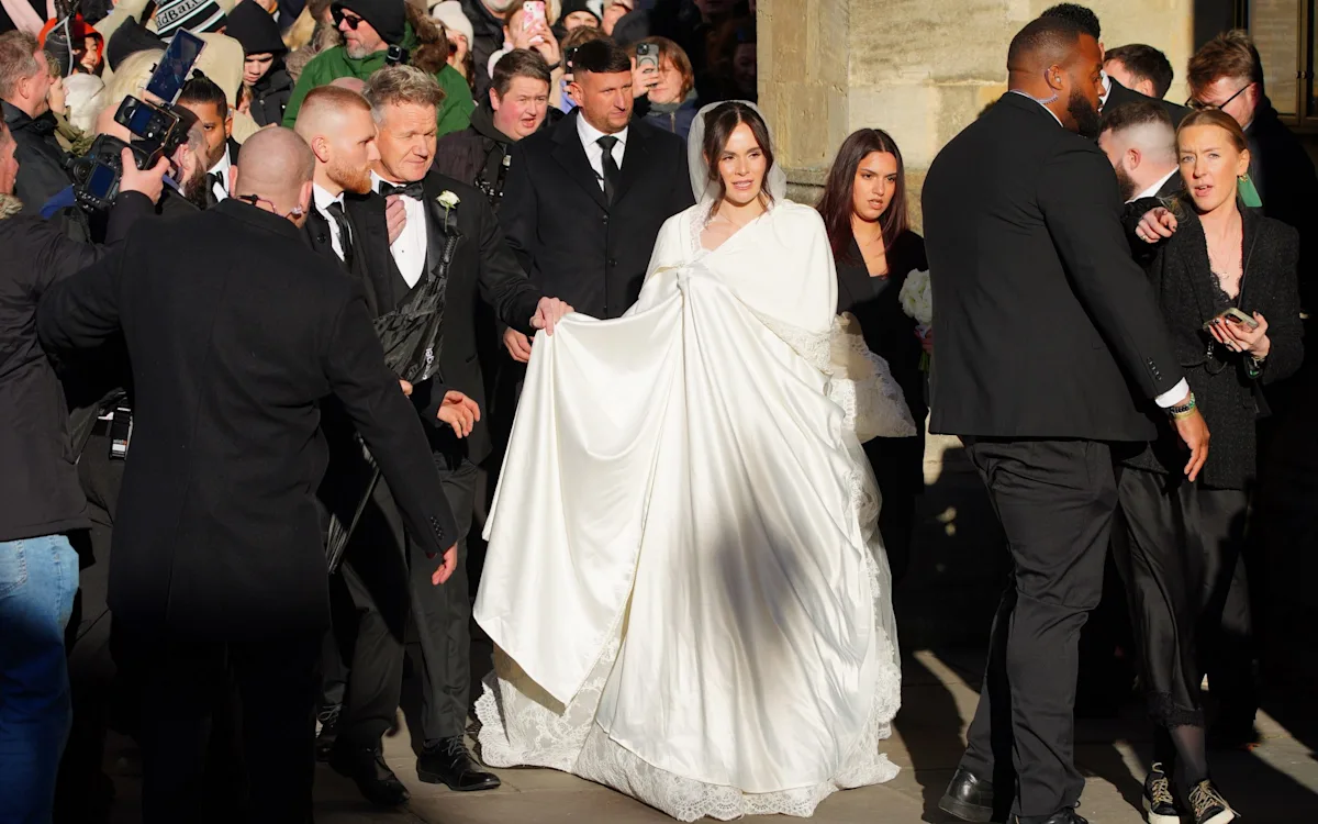 Gordon Ramsay standing in a kitchen, surrounded by culinary delights, with a thoughtful expression, analysing the Peaty family feud and his role in it, with a colour palette of warm and inviting tones