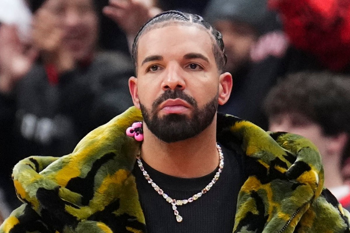 Drake, the Canadian rapper, posing with a sombre expression, highlighting his self-deprecating behaviour and introspective personality, with a cityscape in the background, symbolising his rise to fame and success in the music industry
