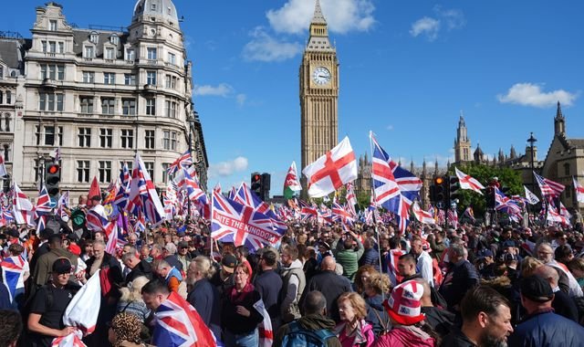 A crowd of protesters holding signs and banners, with a prominent landmark in the background, during a pro-Palestine rally in London, highlighting the city's rich history of activism and protest