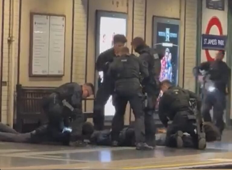 Armed Met Police officers at a London Tube station, detaining suspects in a dramatic arrest, with a city landscape in the background, showcasing the police's commitment to keeping London safe and secure, with a focus on the primary keyword, Met Police