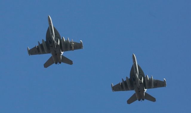 A US air show featuring military jets, with a focus on the primary keyword 'air show crash' and the devastating incident that occurred, resulting in the ejection of four crew members and sparking concerns about air safety