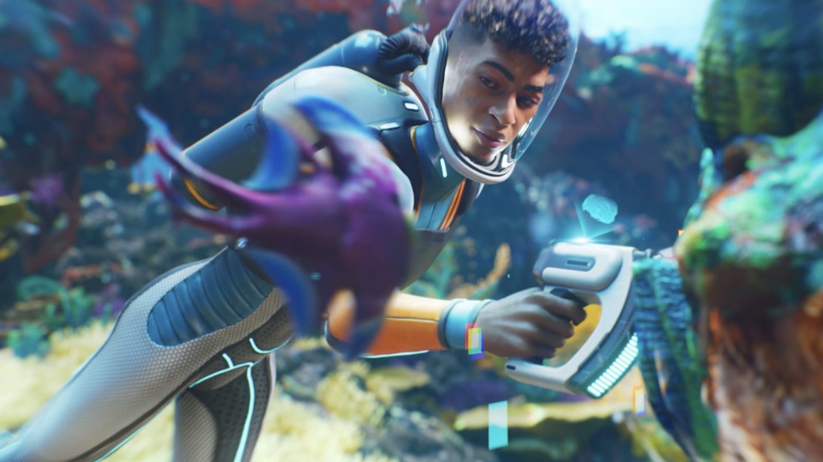 A UK gamer exploring the alien ocean in Subnautica 2, with a school of fish swimming in the background, as they search for silver to craft their first air tank, with the colour of the ocean and the fish adding to the game's immersive atmosphere