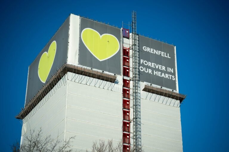 The Grenfell Tower fire was a devastating tragedy that claimed the lives of 72 people. The incident occurred on 14 June 2017, and since then, the families of the victims have been waiting for justice. The primary keyword is Grenfell Tower fire, which has been a major news story in the UK. The image shows the tower on fire, with flames engulfing the building. The colour of the flames is a deep orange, and the smoke is billowing into the air. The behaviour of the emergency services on the night of the fire has been widely criticized.
