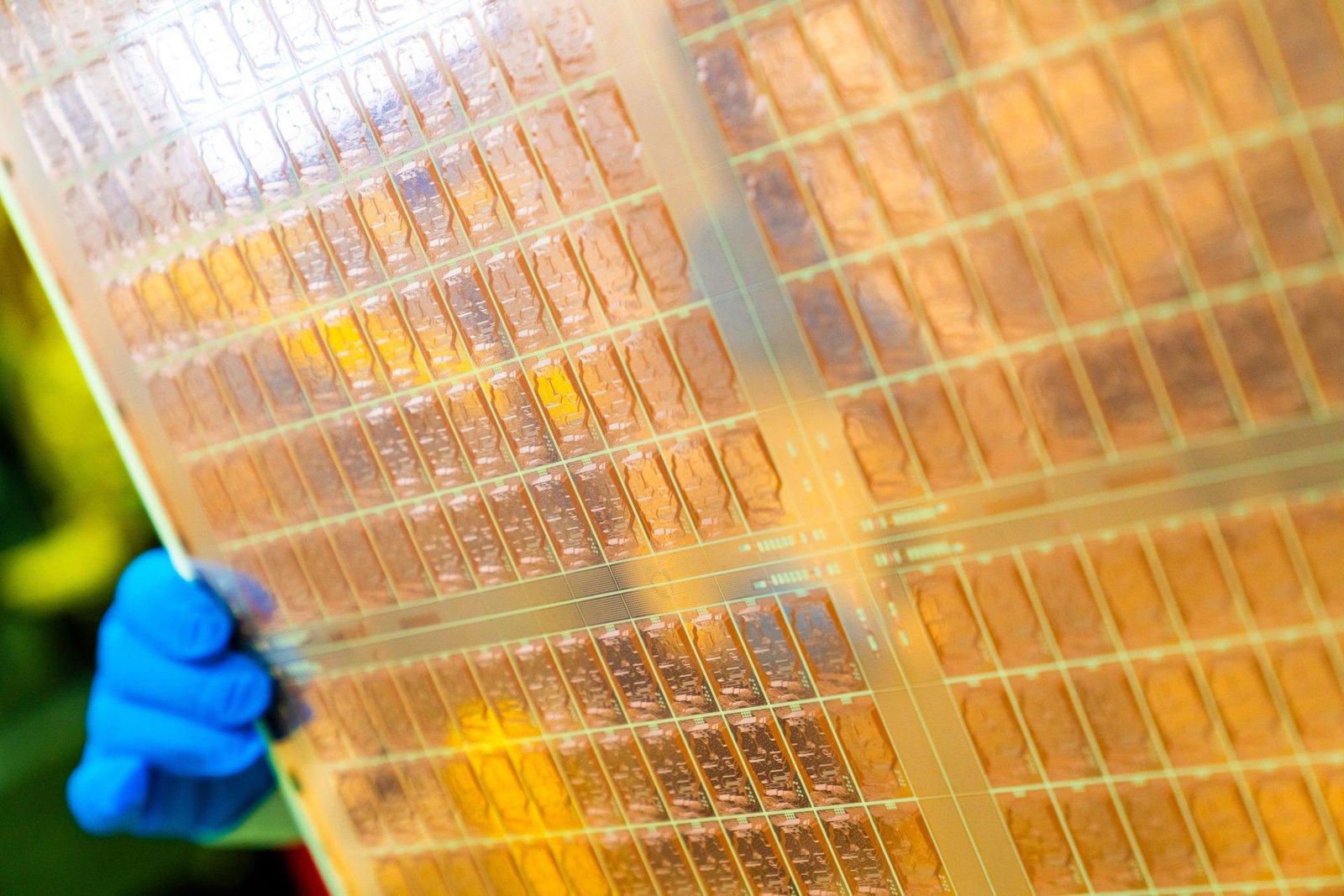 A close-up of the Glass Core Substrate prototype, featuring co-packaged optics and a unique glass-core substrate design, showcasing the future of UK chip technology and innovation in the tech industry