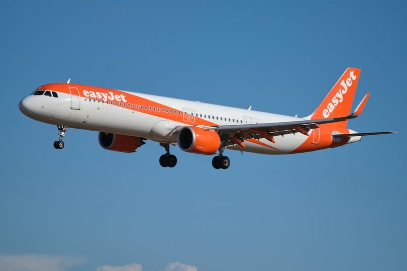 An EasyJet plane making an emergency landing due to a power bank in a passenger's luggage, the primary keyword is emergency landing and airline safety, the image shows the plane landing safely with passengers on board, the power bank was the cause of the incident and it is essential to handle electronic devices properly during flights