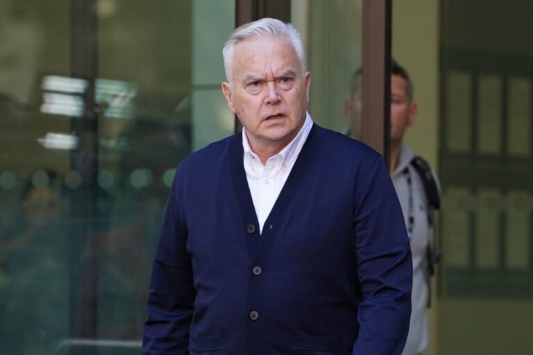 Huw Edwards, a renowned newsreader, posing for a photo with a serious expression, as he prepares to share his side of the story in a new Channel 4 series, with a colourful background that reflects the complexities of his situation