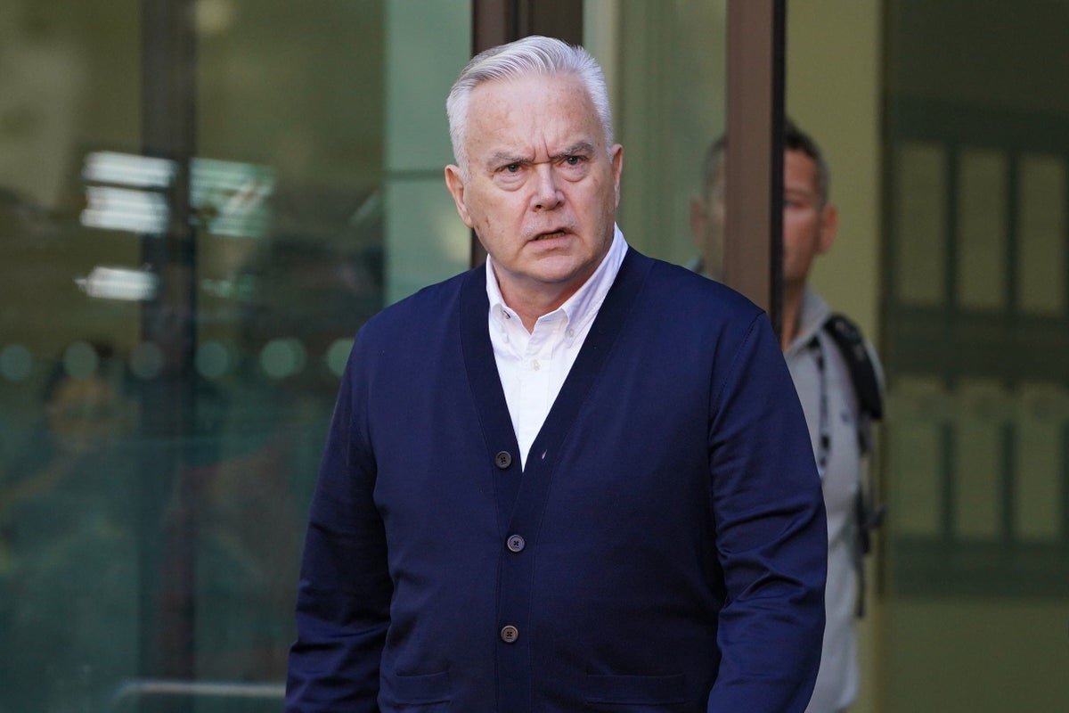 Huw Edwards, a renowned newsreader, posing for a photo with a serious expression, as he prepares to share his side of the story in a new Channel 4 series, with a colourful background that reflects the complexities of his situation