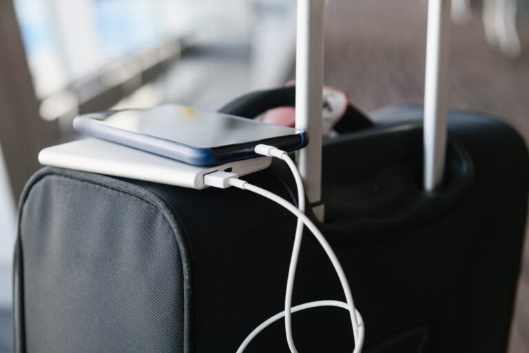 A portable charger with a plane taking off in the background, highlighting the importance of understanding airline regulations regarding portable chargers on flights, with a focus on safety and convenience for travellers.