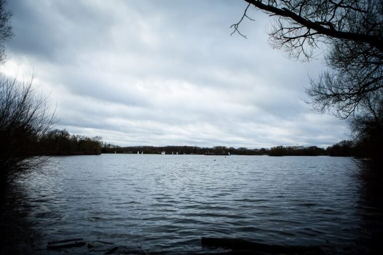 Aerial view of Kingsbury Water Park with a sombre mood, teenage girl's body recovered from the water, investigation ongoing, water safety concerns raised