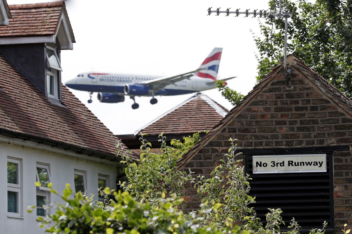 Aerial view of Heathrow Airport, with a new runway under construction, highlighting the potential impact on the environment and local community