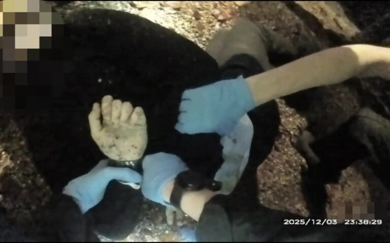 A man struggles to breathe while being restrained by police officers, highlighting the desperate plea of 'I can't breathe' that has become synonymous with police brutality cases, including the tragic incident of Henry Nowak