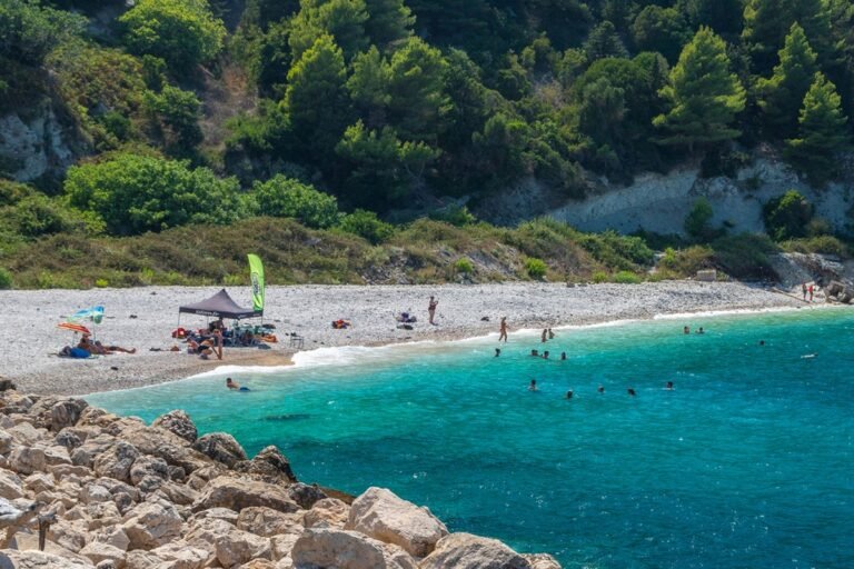 Aerial view of Sazan Island, showcasing its stunning natural beauty and unique landscape, with a glimpse of its 3,500 bunkers and tunnels, a former Albanian ex-military base purchased by Ivanka Trump and Jared Kushner, surrounded by crystal-clear waters and lush green forests