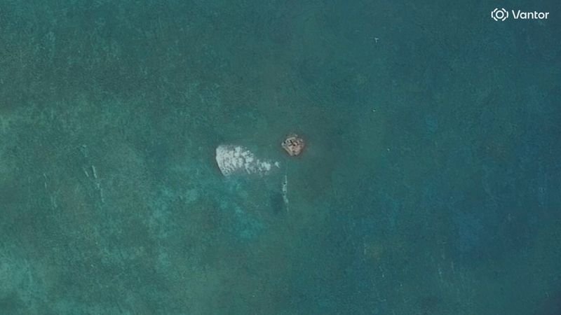 A satellite image of the disputed South China Sea atoll, showing a suspected structure, with the colour of the water appearing calm, but with many complex issues at play, including the role of China in the region, and the importance of monitoring the area, with the primary keyword being South China Sea