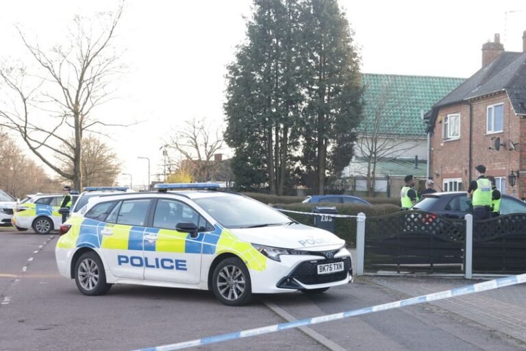 A parked car with a memorial of flowers and tributes to the deceased West Midlands Police detective, who tragically died from burn injuries, with a primary focus on the detective death inquest and investigation