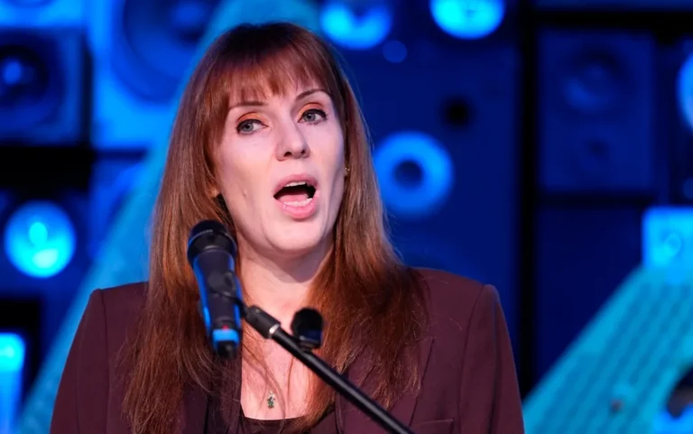 A bustling UK pub with customers enjoying drinks and conversation, highlighting the importance of pub support and the need to protect these community hubs