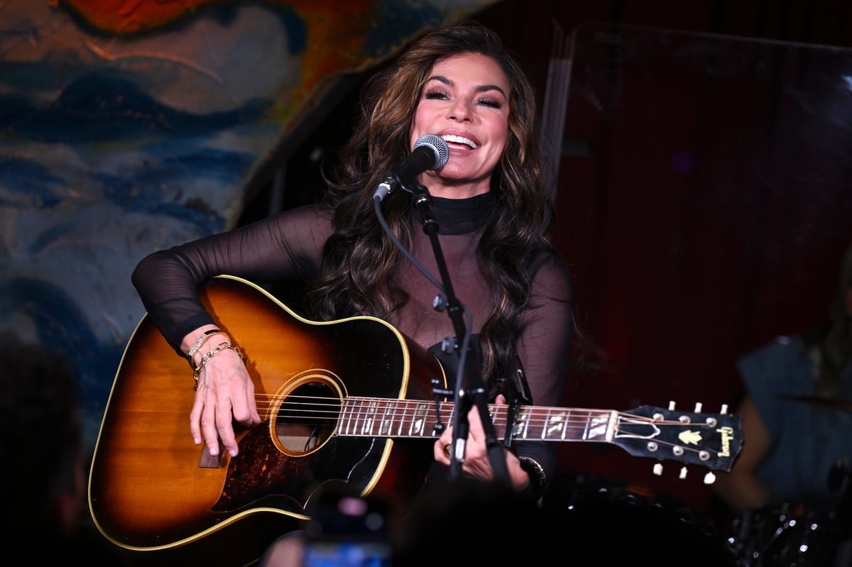 Shania Twain performing live at an intimate east London pub gig, surrounded by fans and delivering a high-energy performance with her unique blend of country-pop music
