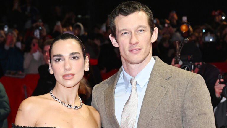 Dua Lipa and Callum Turner exchanging vows in a romantic Sicilian ceremony, surrounded by stunning landscapes and beautiful colour schemes, a perfect example of a celebrity wedding in Sicily