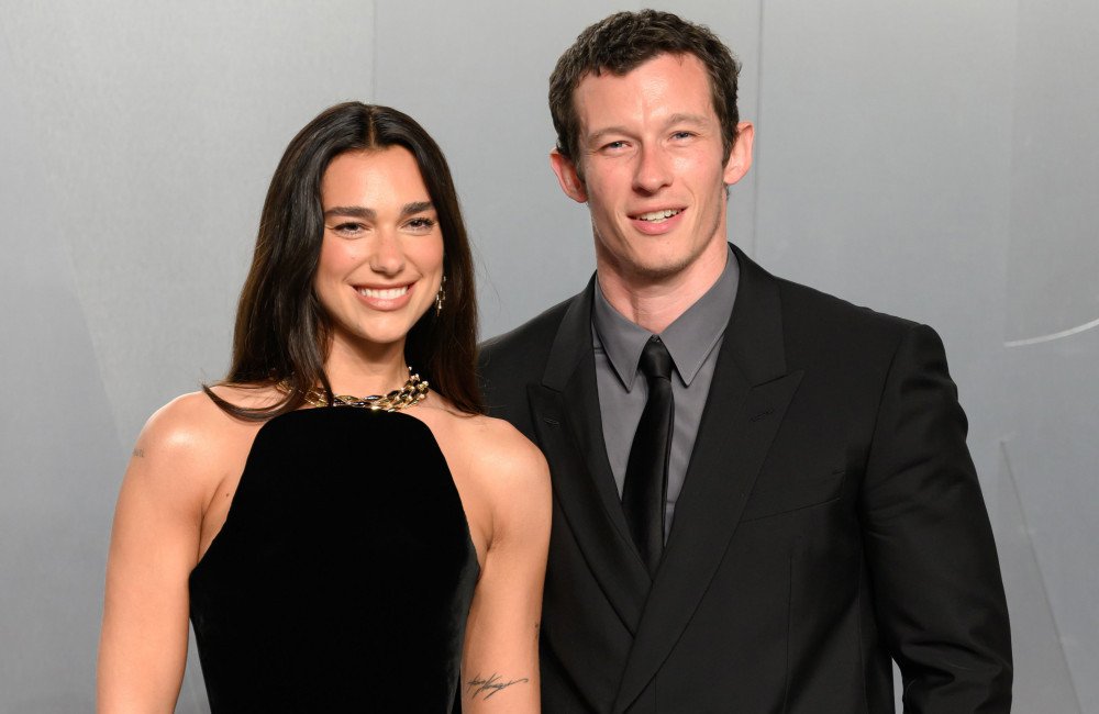 Dua Lipa and Callum Turner posing together on their honeymoon at a luxury hotel with a stunning background, highlighting their love and happiness, with a beautiful colour palette and serene atmosphere