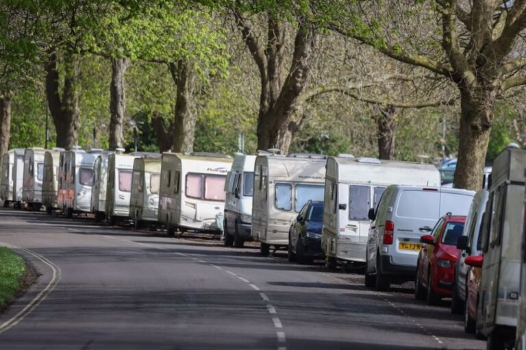 A van parked in a scenic area with a stunning view of the Downs, highlighting the beauty of the location while also raising questions about the impact of van dwellers on the environment and local communities, with a focus on the primary keyword 'van dwellers'