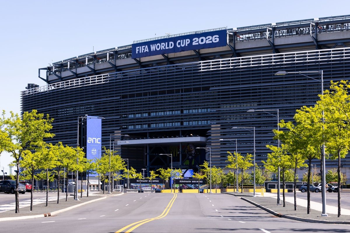 A mother looking at her computer screen with a shocked expression, with a World Cup ticket and parking pass on the desk, surrounded by football-related items, highlighting the primary keyword phrase 'World Cup tickets'