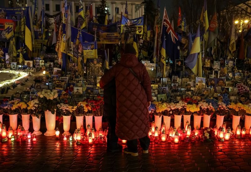 A young Ukrainian woman stands proudly, symbolising the country's resilience and determination in the face of adversity, with a subtle reference to the Ukraine conflict and Russian recruitment of young women