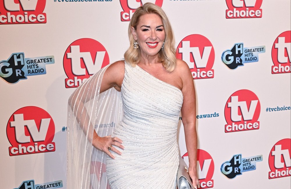 Claire Sweeney, a British actress, is considering a return to Coronation Street, a popular UK TV soap opera. She is pictured on set, surrounded by crew members and cameras. The scene is filled with colour and activity, capturing the essence of the show. Claire Sweeney's potential comeback has sparked excitement among fans, who are eager to see what the future holds for her character. The show's producers will need to handle her return carefully, ensuring that it is consistent with the show's overall tone and style. The possibility of her return has generated significant interest, with many fans taking to social media to express their enthusiasm
