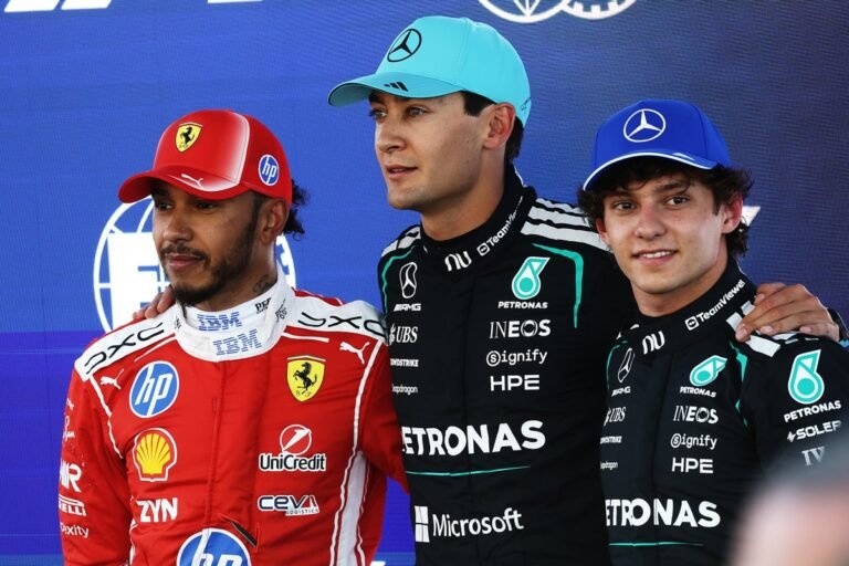 Lewis Hamilton in his Formula 1 car, racing at high speed on the Barcelona track, with a crowd of spectators in the background, watching the action unfold with great interest and anticipation, as the primary keyword phrase F1 standings is on display