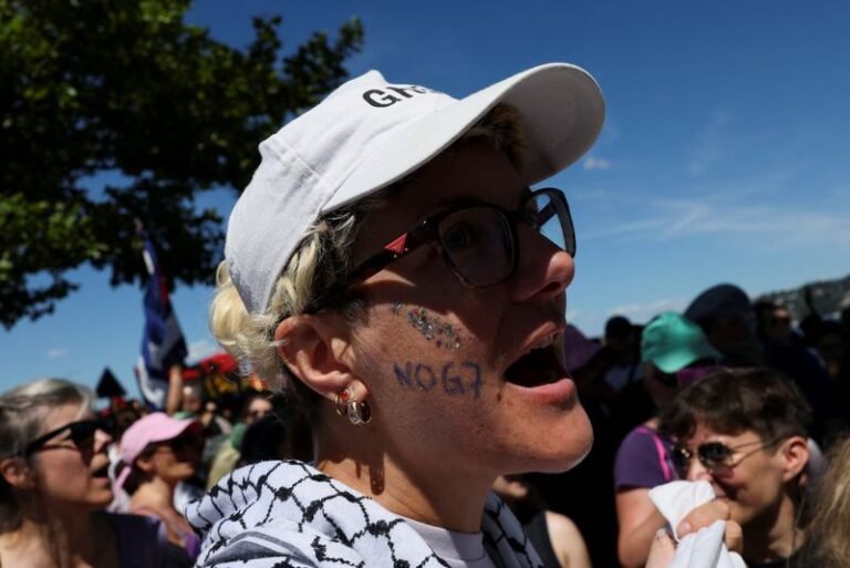 Rioters clash with authorities in Geneva as anti-G7 protest turns violent, with a Tesla set ablaze and UN office windows smashed, amidst a sea of chaos and destruction, with the primary keyword being anti-G7 protest