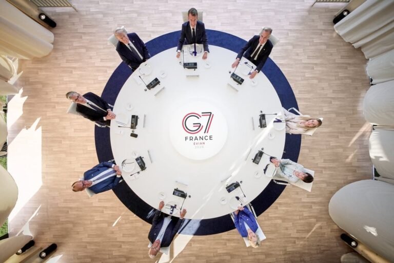 Aerial photo of G7 world leaders, including Trump, with a mix of emotions and expressions, set against a vibrant and colourful background, highlighting the intricacies of international diplomacy and global cooperation