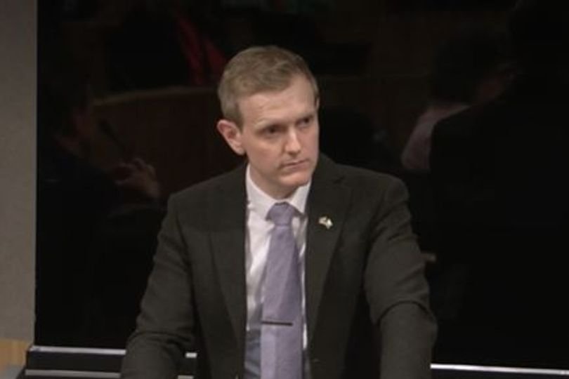 Politicians walking out of the Senedd building in protest over Reform UK MS's comments, with a mix of anger and frustration on their faces, highlighting the need for greater accountability in politics