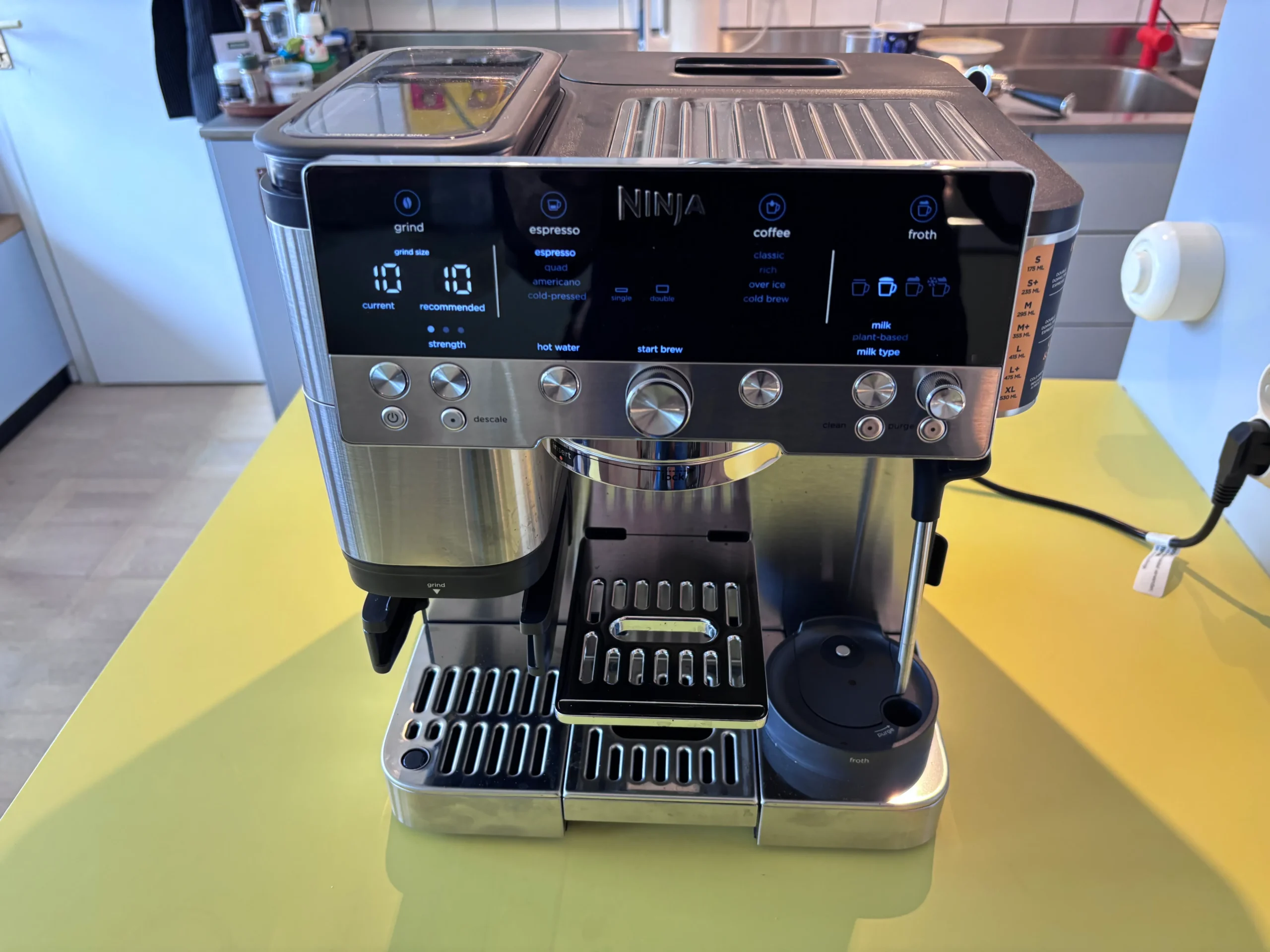 The Ninja Luxe Café Premier coffee machine, featuring a sleek silver design and advanced controls, is capable of producing high-quality coffee with its semi-automatic brewing process and customisation options, including a built-in milk frother.