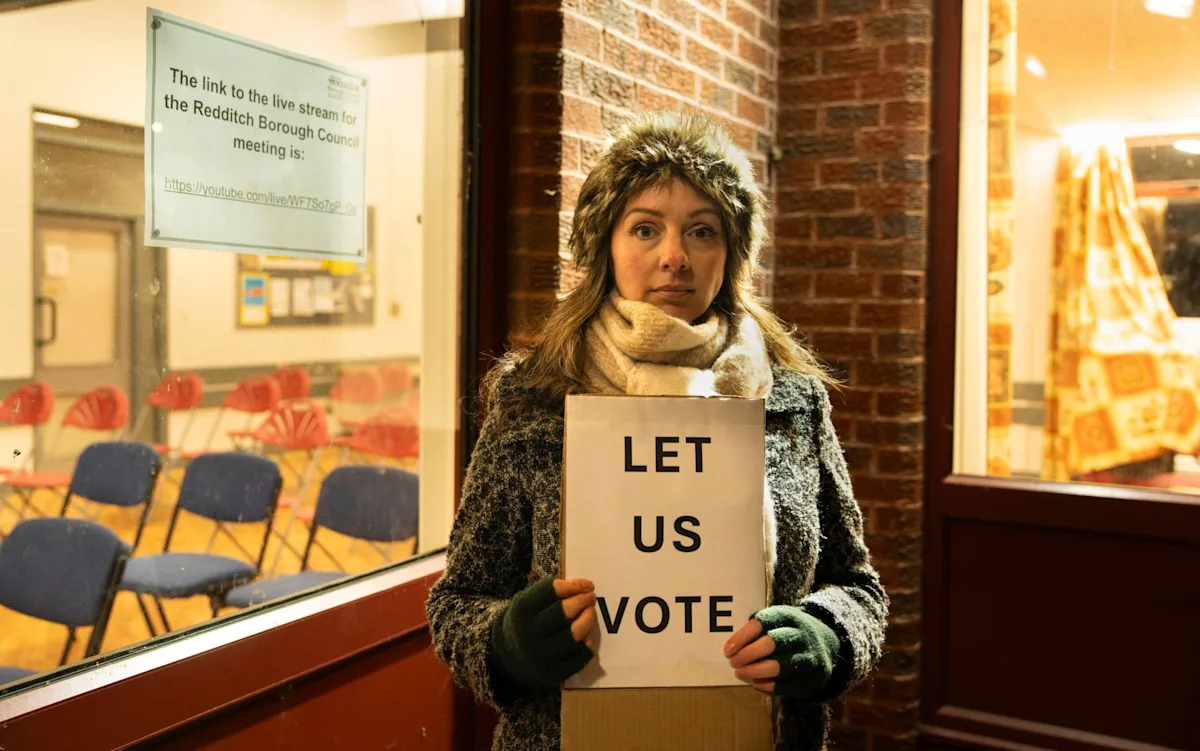 Keir Starmer, Labour Party leader, speaking at a podium with a backdrop of the UK flag, symbolising the party's commitment to democratic values and its role in shaping the country's future, with a focus on local elections and community engagement
