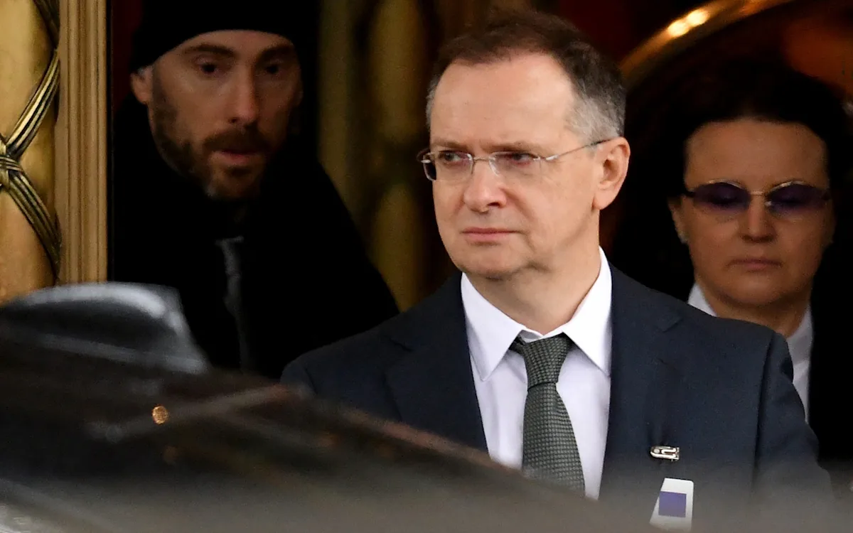 Descriptive image of Ukraine peace talks delegates gathered around a table, with a primary focus on the Ukraine peace talks and conflict resolution, highlighting the tense negotiations and diplomatic efforts to resolve the ongoing conflict