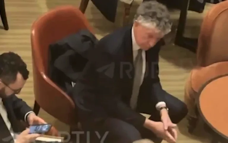 A luxurious lobby with dignitaries and diplomats gathered for the Ukraine peace talks, showcasing the hotel's impeccable service and lavish decor, highlighting the primary keyword of Ukraine peace talks