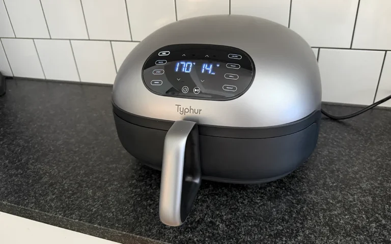 The Typhur Dome 2 air fryer in action, cooking a large pizza with ease. The air fryer's large cooking surface and dual heating elements make it perfect for cooking meals in bulk. With its self-cleaning function and non-stick ceramic coating, this air fryer is a breeze to use and clean.