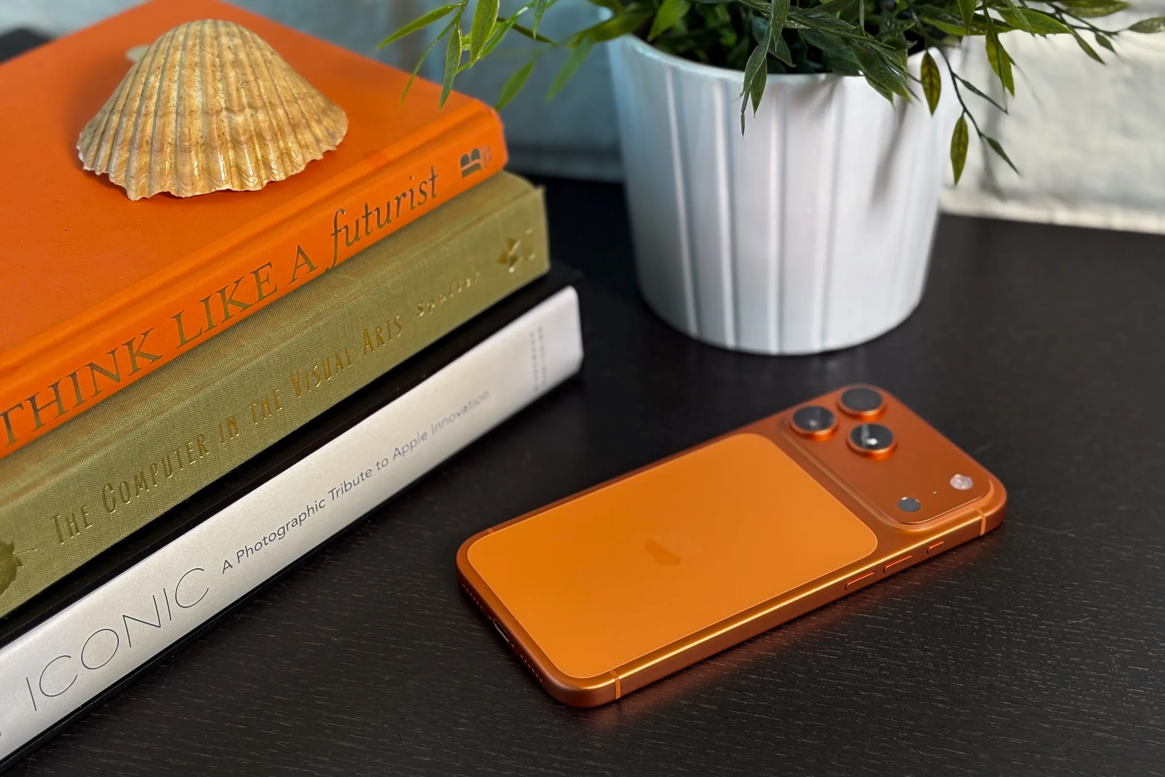 A person holding an iPhone 17 with a customised lock screen and Spatial Scenes feature enabled, showcasing the device's advanced features and capabilities.